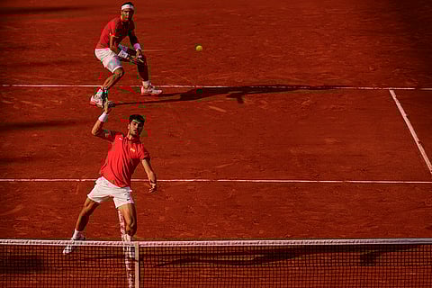 Carlos Alcaraz returns a ball